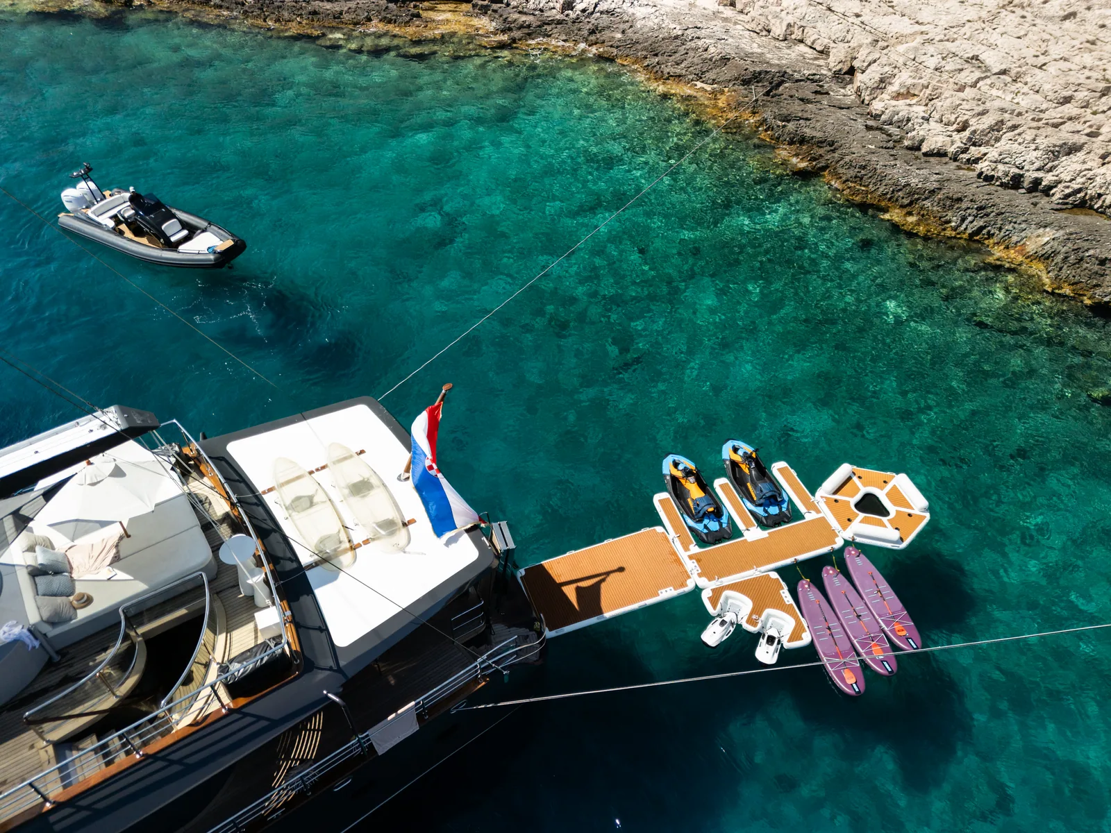 The swim platform with jet skis and paddleboards, seen from above