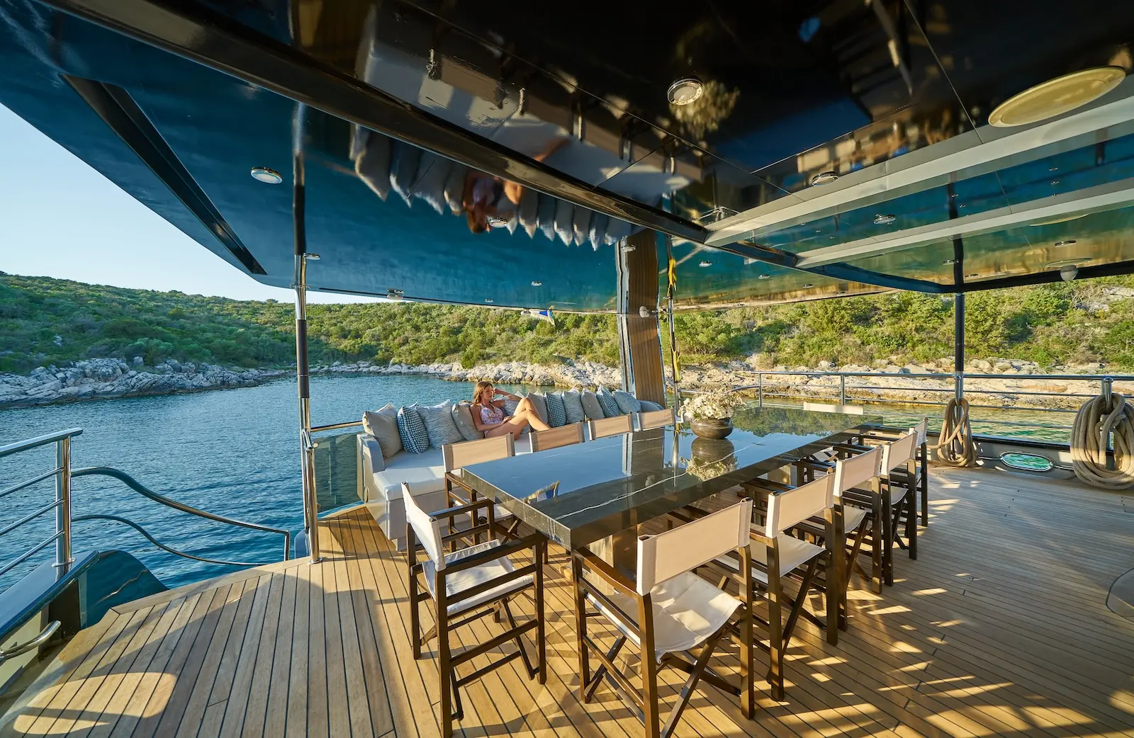 Aft deck lounge of Rara Avis facing an open sea view at sunset