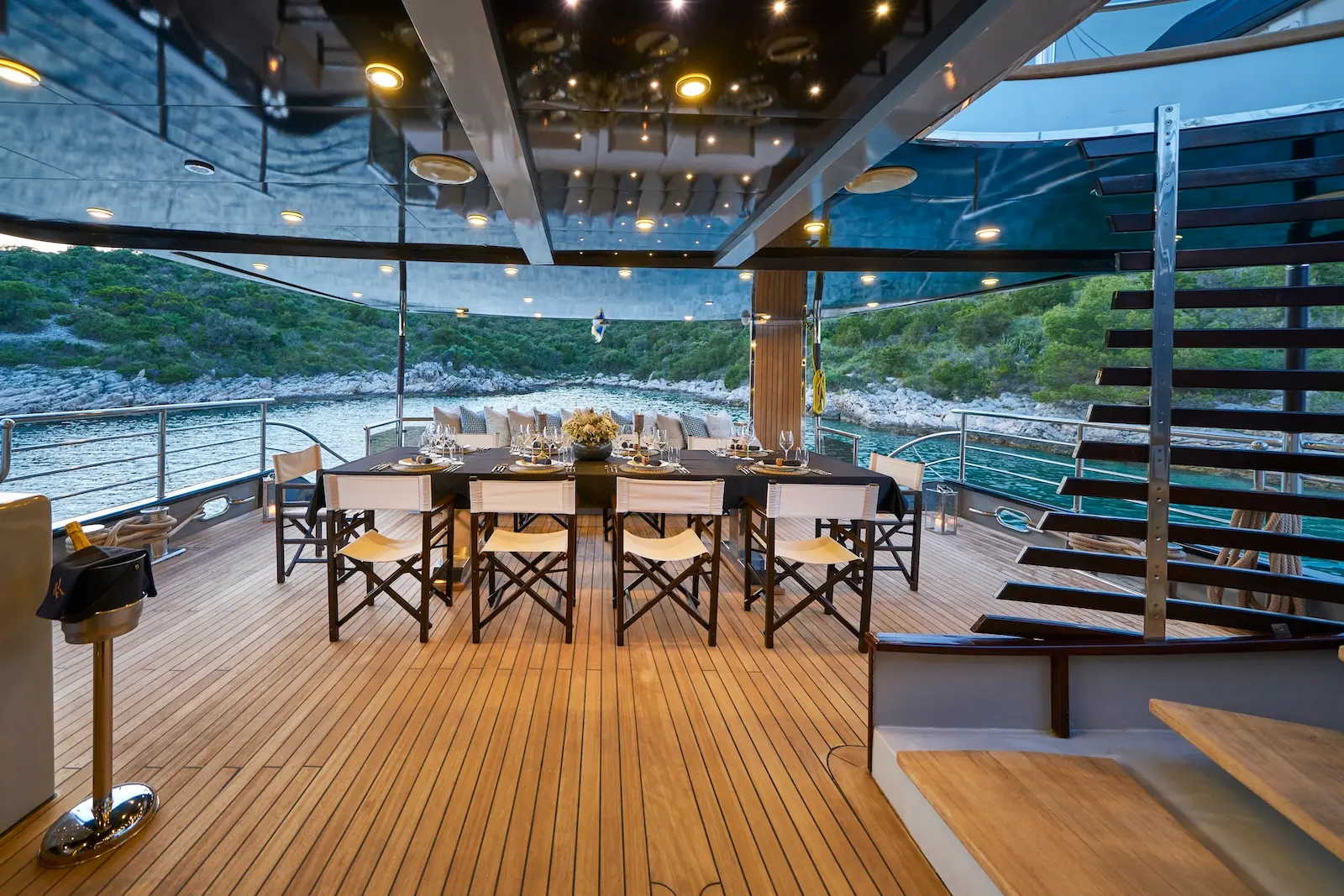 Alfresco dining table set on the deck of Rara Avis in the evening