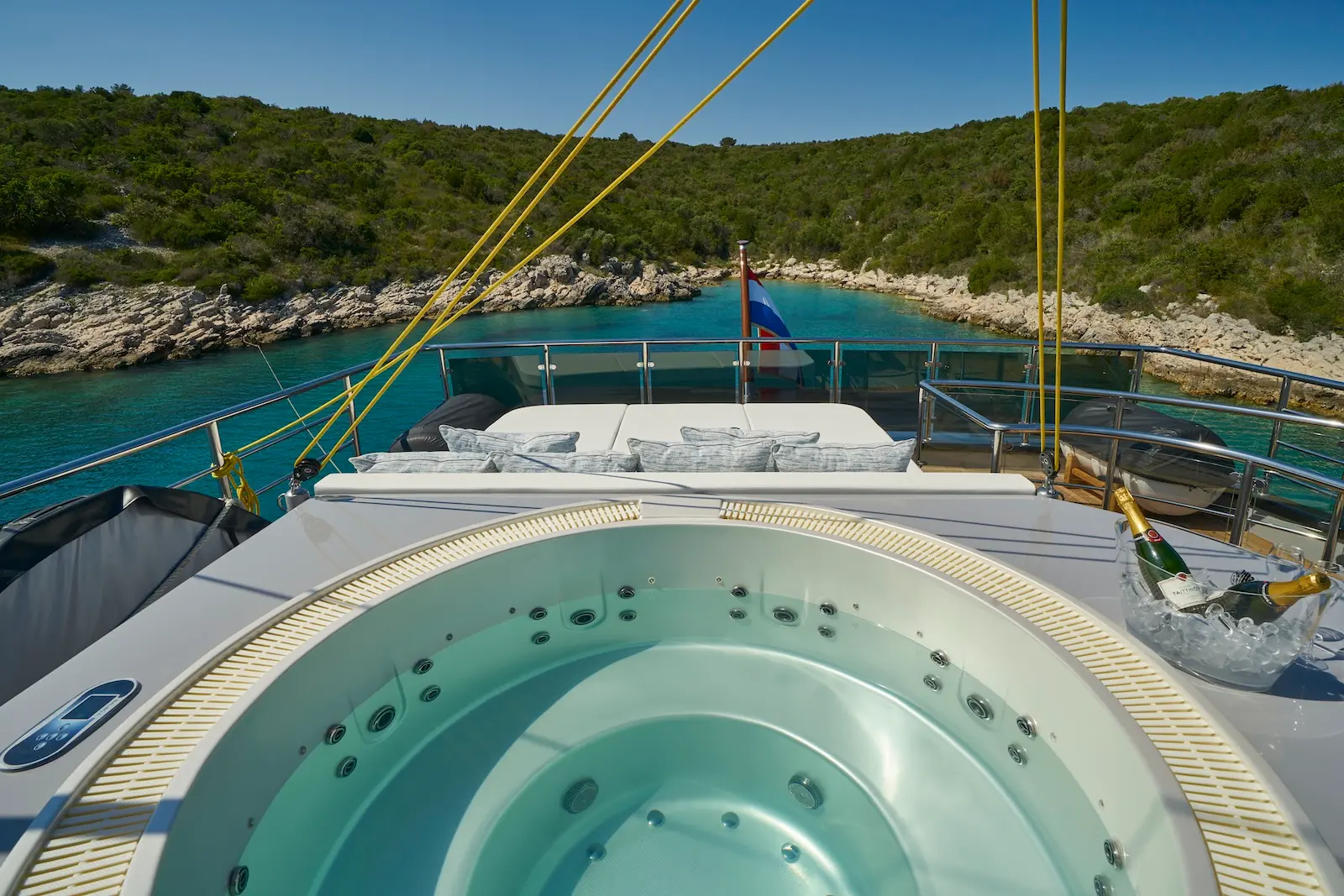 Foredeck jacuzzi on Rara Avis with champagne at dusk in Croatia