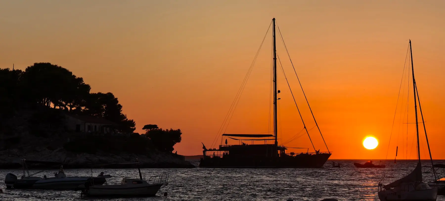 S/Y Rara Avis at anchor in a Croatian bay at sunset